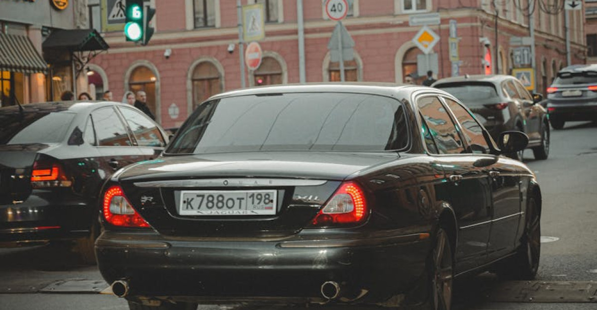 Classic car driving on a busy street in Saint Petersburg Russia during dusk