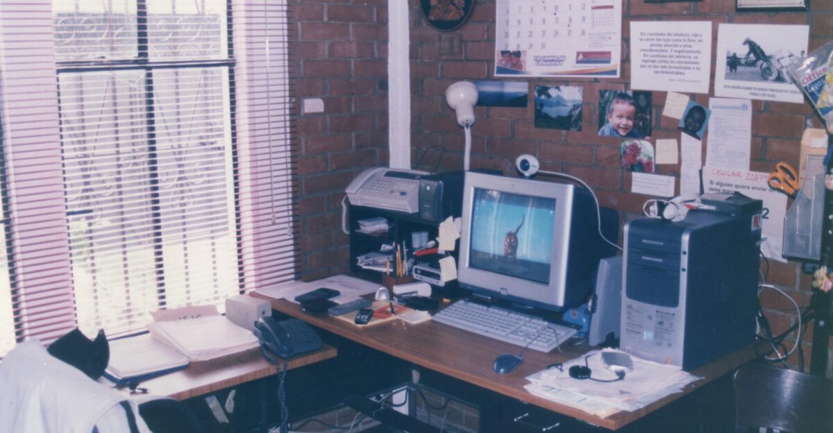 A nostalgic vintage office setup featuring retro technology like a CRT monitor and fax machine in Guatemala City