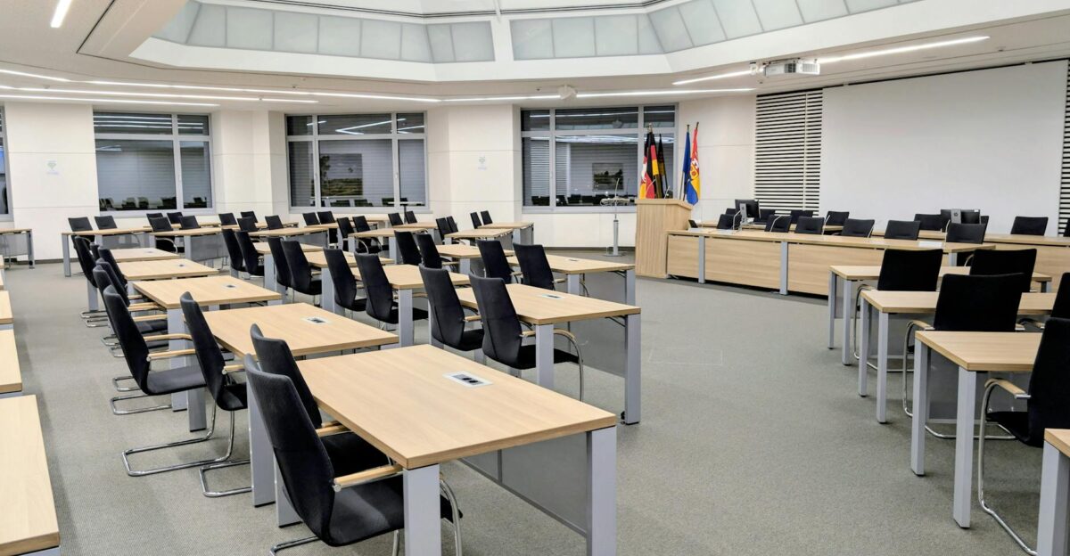 Spacious and modern meeting room in Niedersachsen Germany with desks and flags