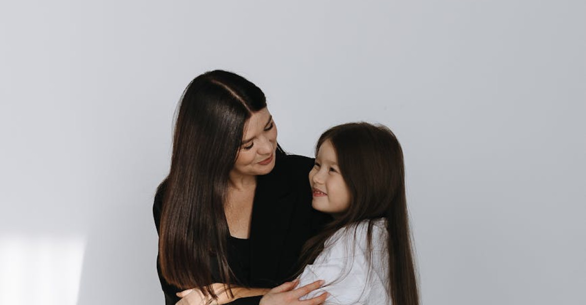 A heartwarming moment between a mother and daughter sharing an embrace in a bright room