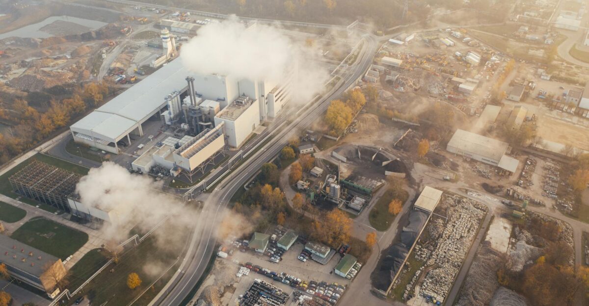 Aerial view showcasing an industrial complex in Pozna Poland emitting smoke and steam