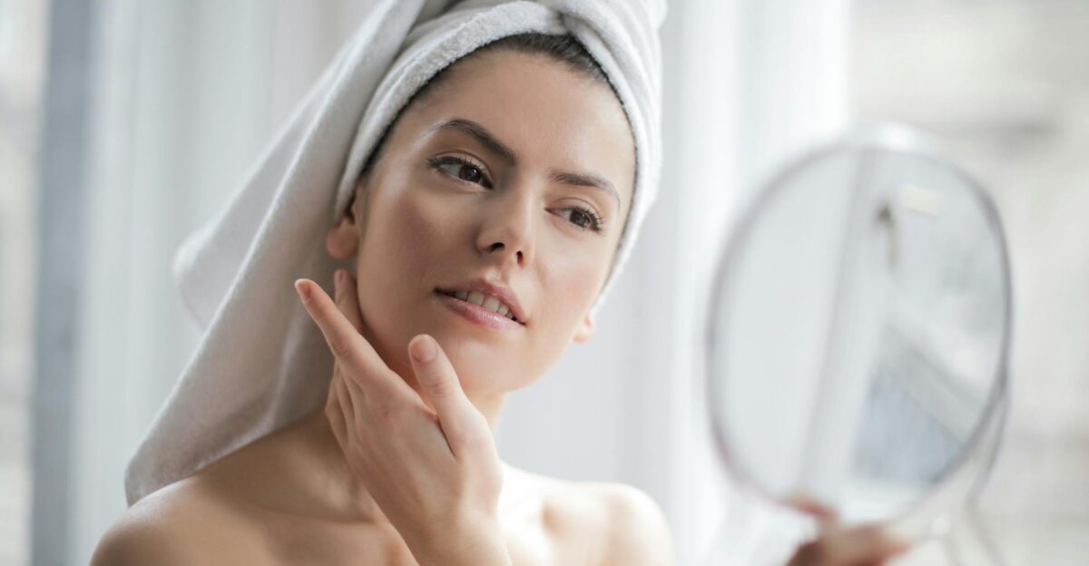 A serene and elegant woman enjoys a skincare ritual enhancing her natural beauty in the comfort of her home