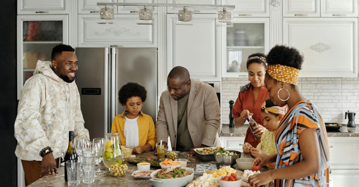 A joyful family together in the kitchen preparing and enjoying a meal