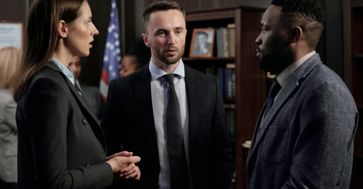 Group of business professionals engaged in a serious discussion inside an office environment