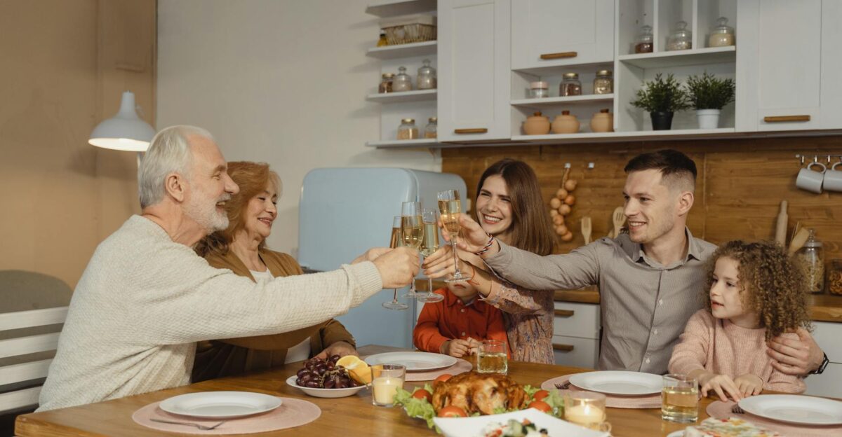 A joyful family toasting at a dinner table indoors celebrating a special occasion