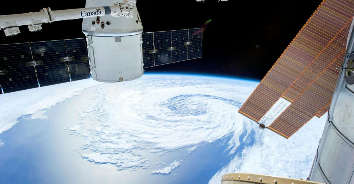 A mesmerizing view of Earth as seen from a space station with solar panels and satellite modules