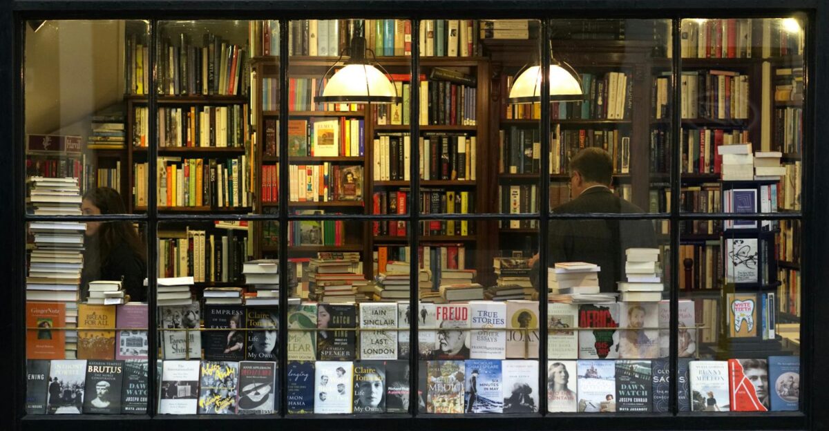 A cozy London bookstore showcasing various books through a classic window display