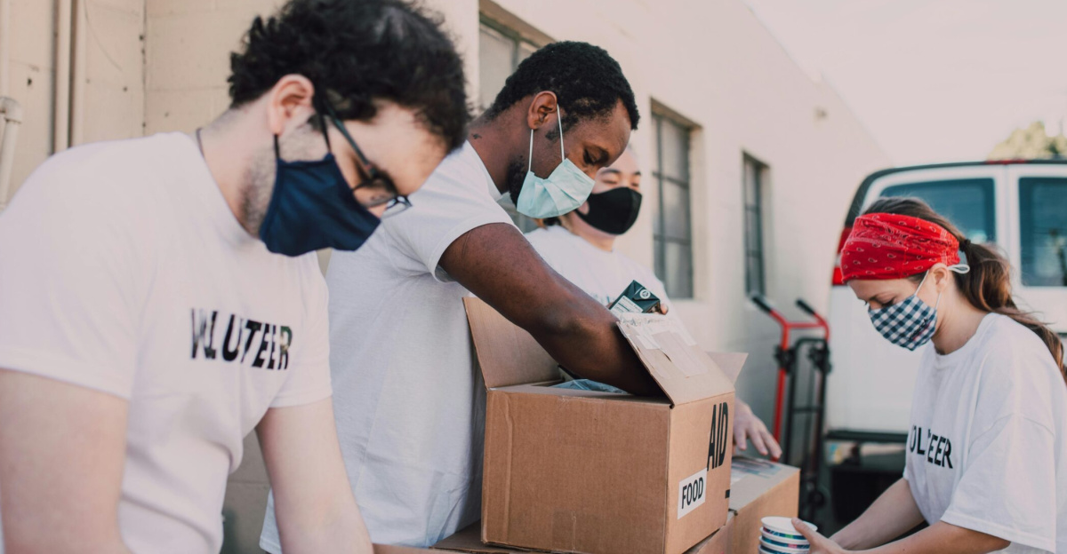 Volunteers packing food donations outdoors to support a local charity event.