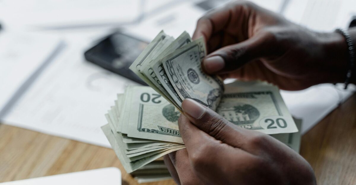 Hands of a Person Counting Cash Money Free Stock Photo
