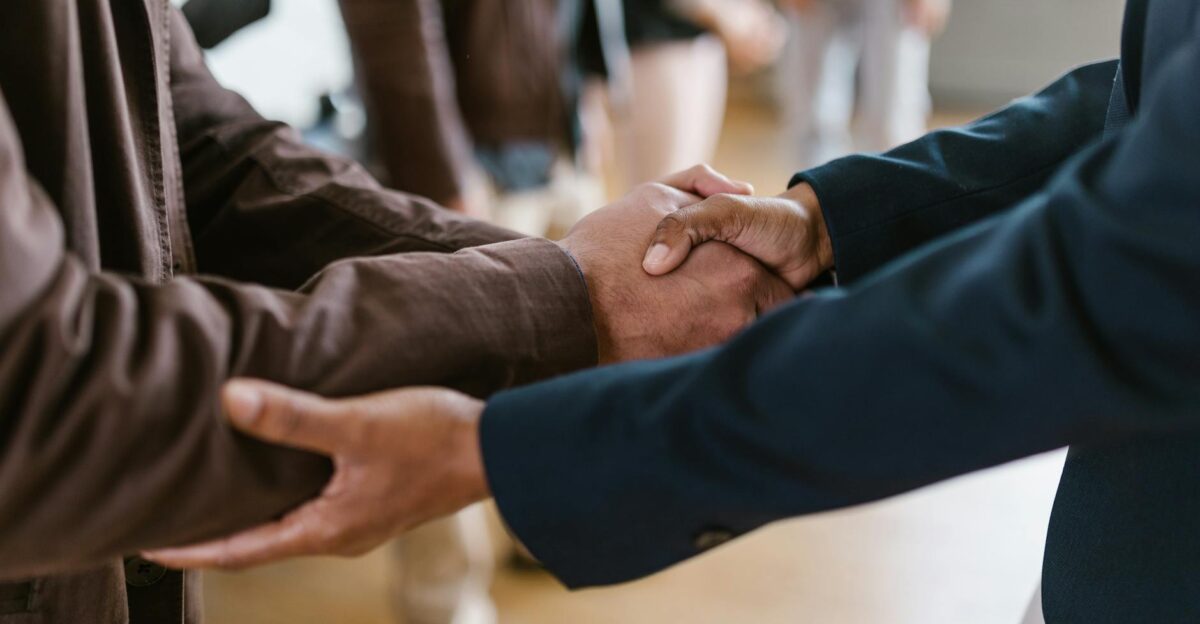 Close-up of two businesspeople shaking hands symbolizing agreement and partnership