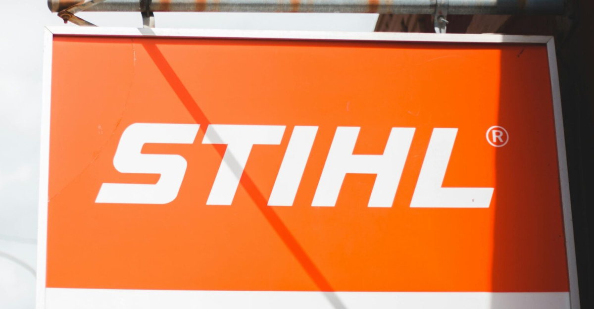 Outdoor STIHL sign in urban environment with clear blue skies and visible streetlamp.