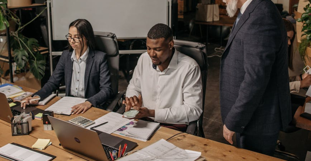 A diverse team collaborating in a modern office setting reviewing documents and reports