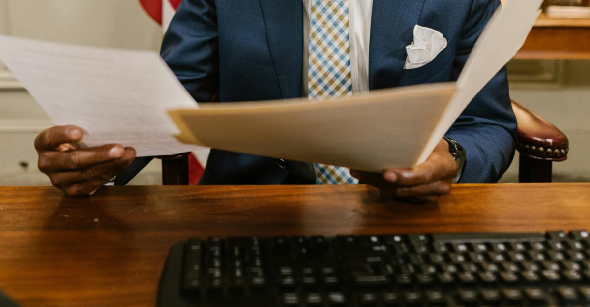 A lawyer reading documents in an office setting, conveying professionalism and focus.