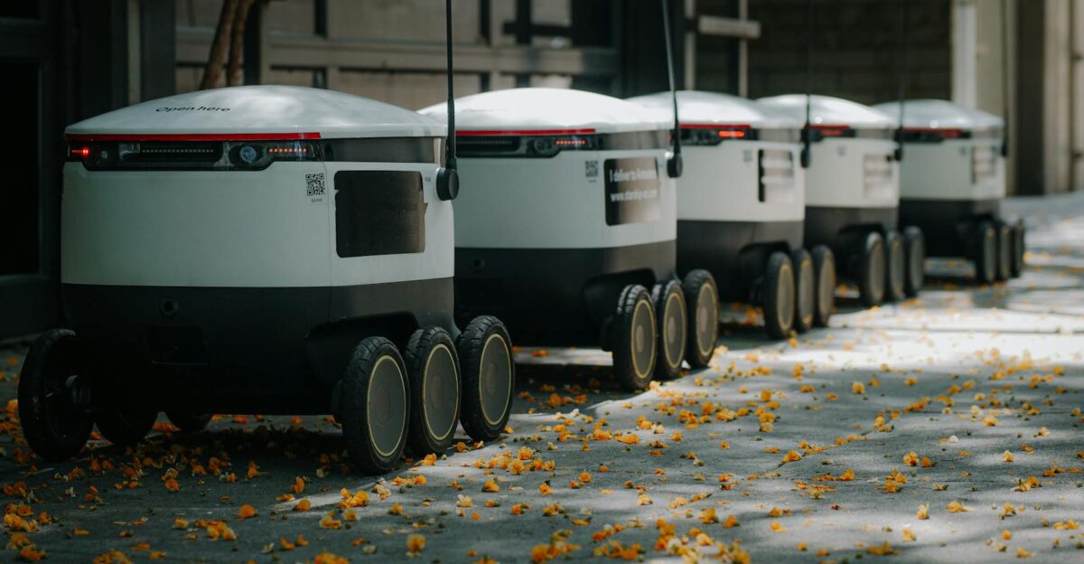 Futuristic delivery robots lined up outdoors showcasing innovative modern technology