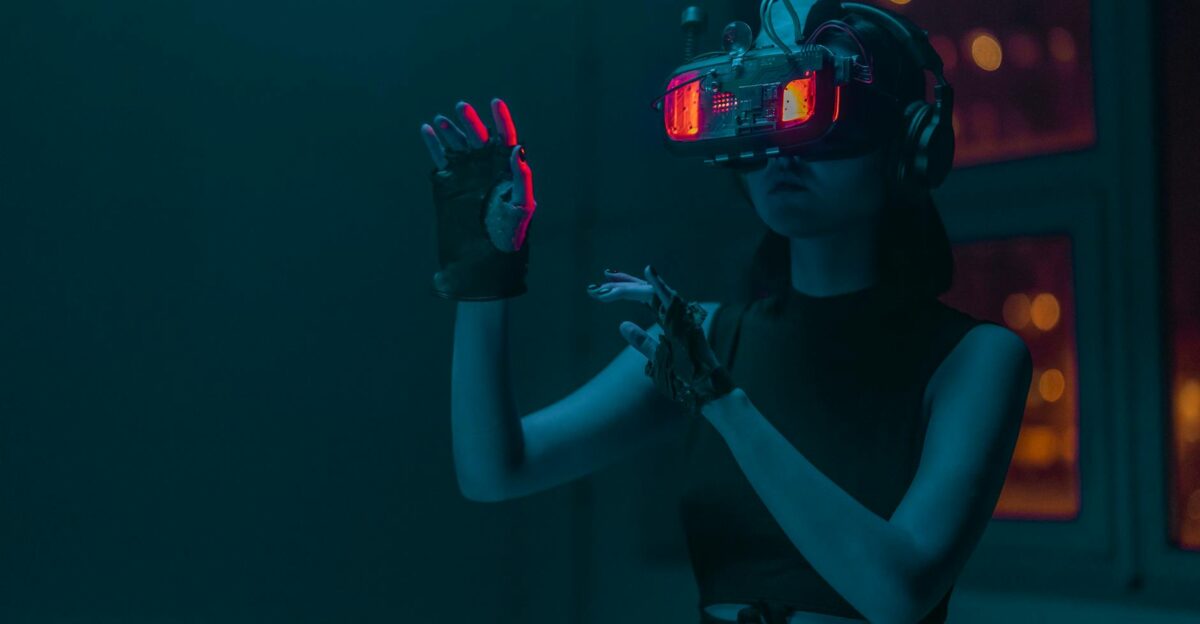 Woman exploring virtual reality with neon lights in a dark studio setting