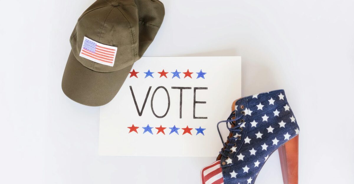 A patriotic setup featuring a cap a vote sign and a high-heeled shoe with US flag design
