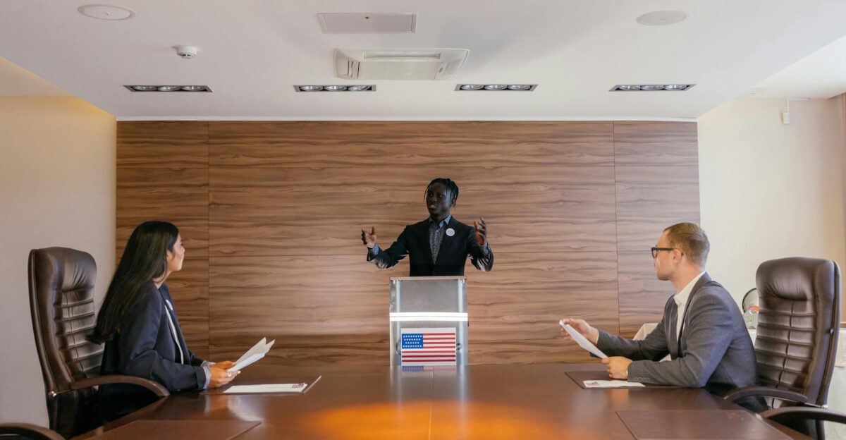 Three professionals deliberating in a modern conference room setting