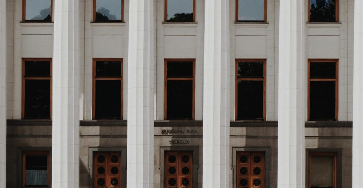 Elegant exterior of Ukraine s parliament building in Kiev with classical columns and pedestrians