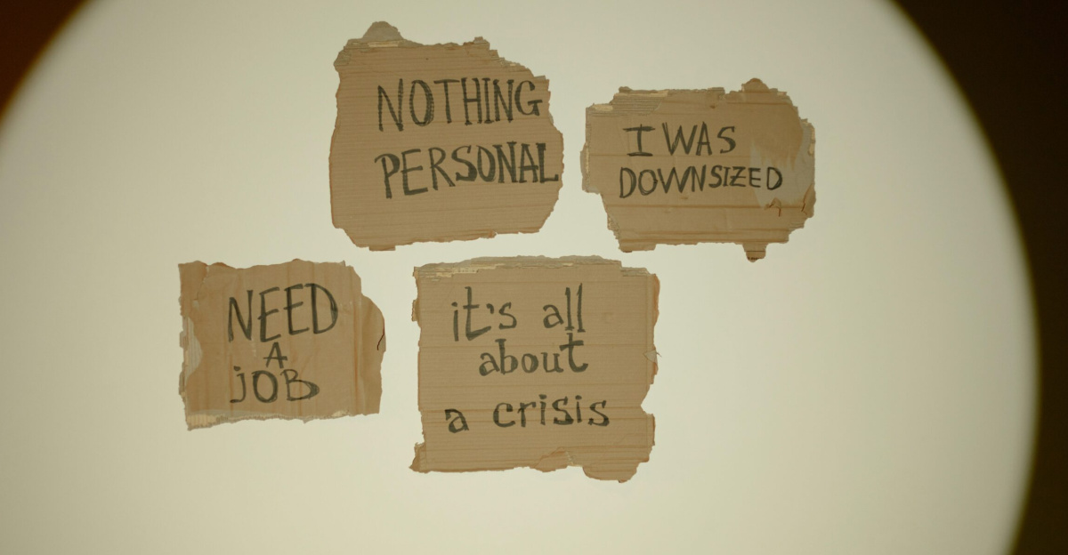 Cardboard signs convey job loss and economic crisis message, ideal for articles on unemployment.