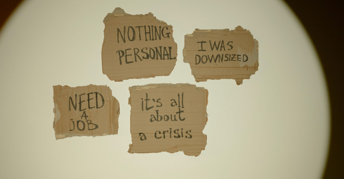 Cardboard signs convey job loss and economic crisis message, ideal for articles on unemployment.