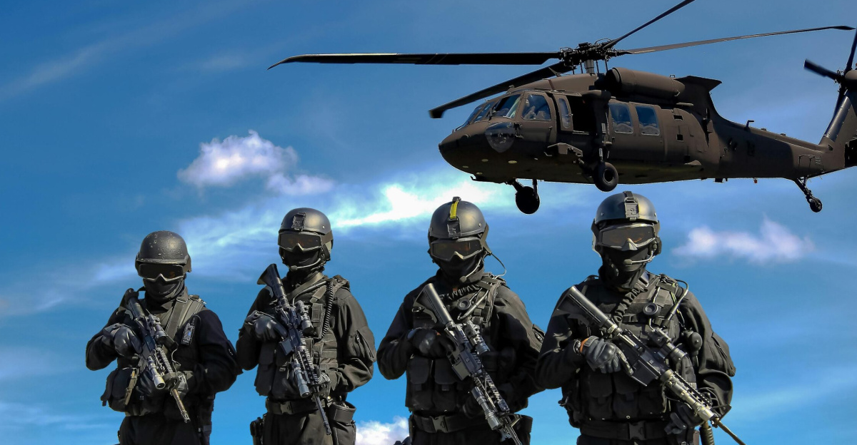Special forces soldiers in tactical gear with helicopter overhead under a blue sky.
