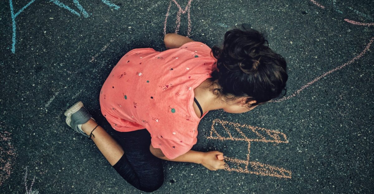 woman painting on gray concrete floor during daytime