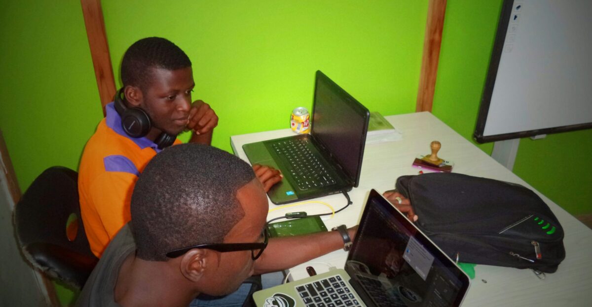 two men using laptop computes