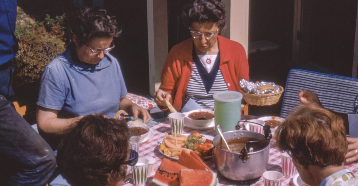 women sitting beside table