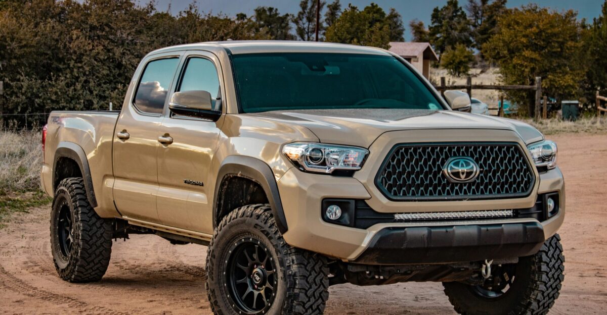 white Toyota crew cab pickup truck on ground