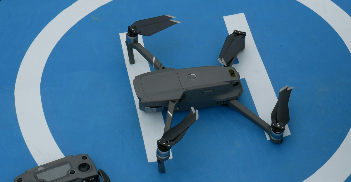 black quadcopter drone beside controller