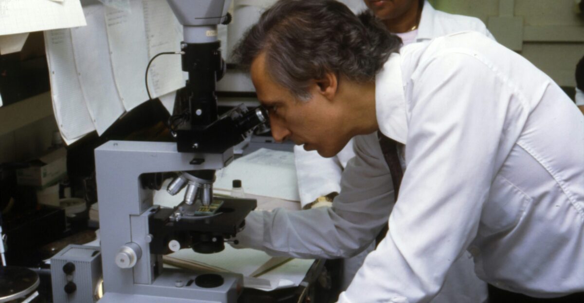 man using microscope