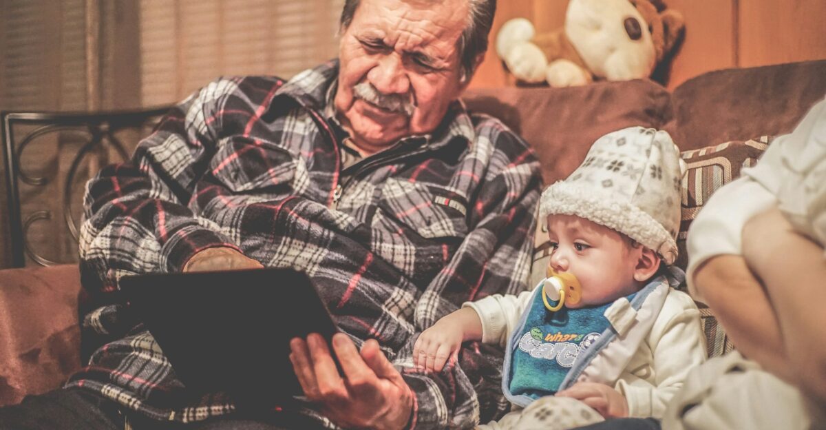 man in plaid shirt holding baby