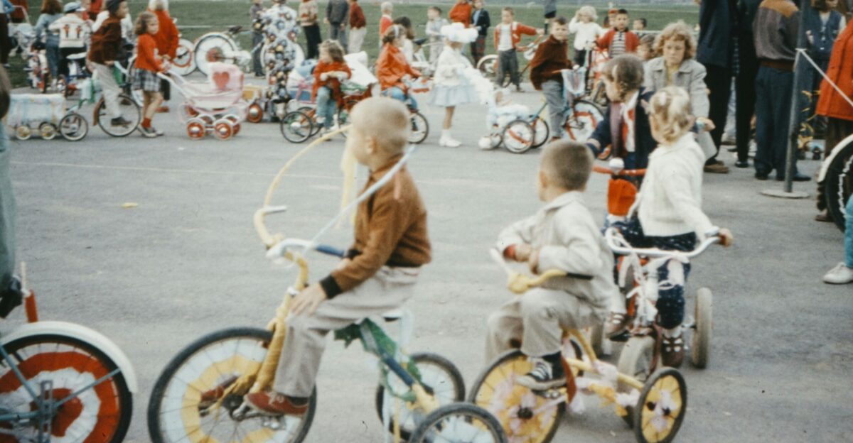 people riding on bicycle on road during daytime
