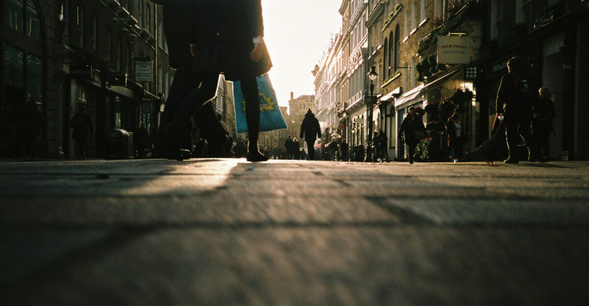 person in black jacket walking on street during daytime