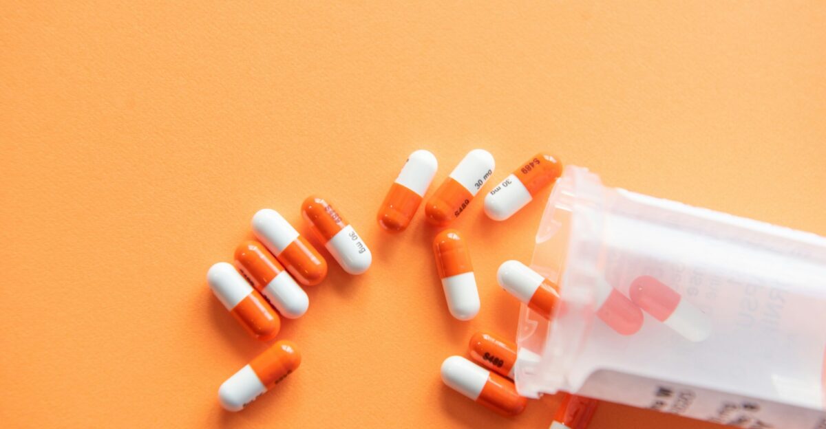 orange and white medication pill