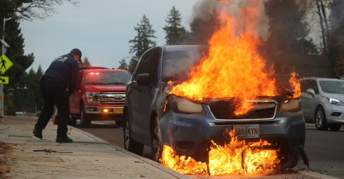 man in black jacket standing near fire