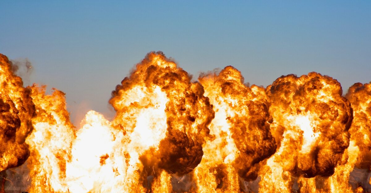 brown and white smoke on brown rock formation