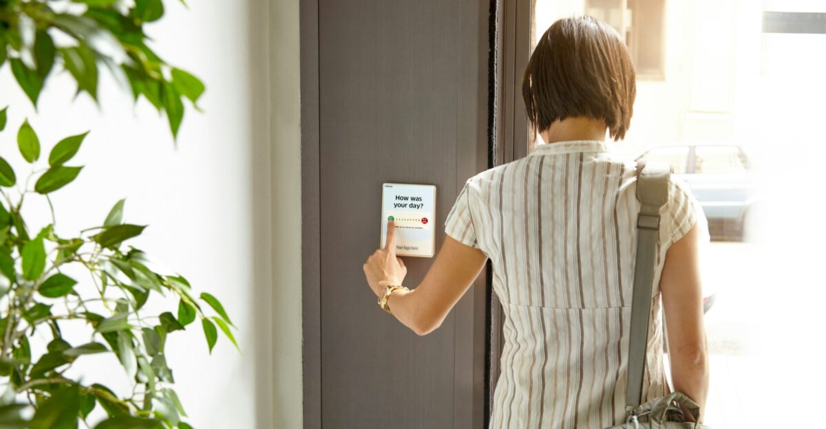 woman in white and black stripe shirt holding white ceramic mug