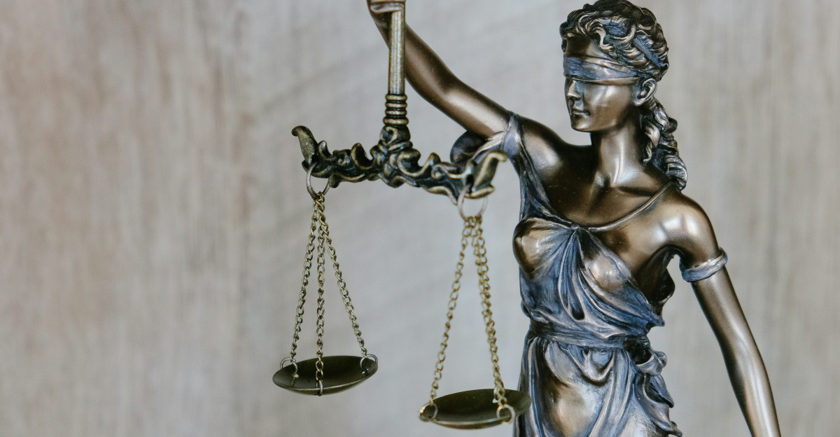 woman holding sword statue during daytime