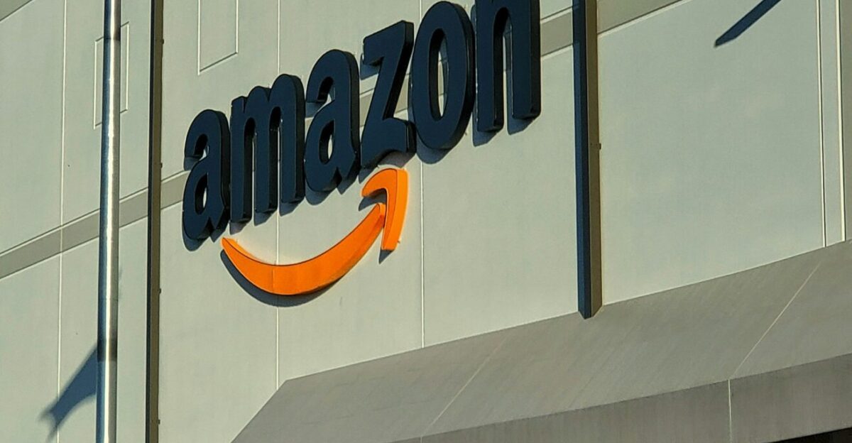 an amazon store with a person sitting in front of it