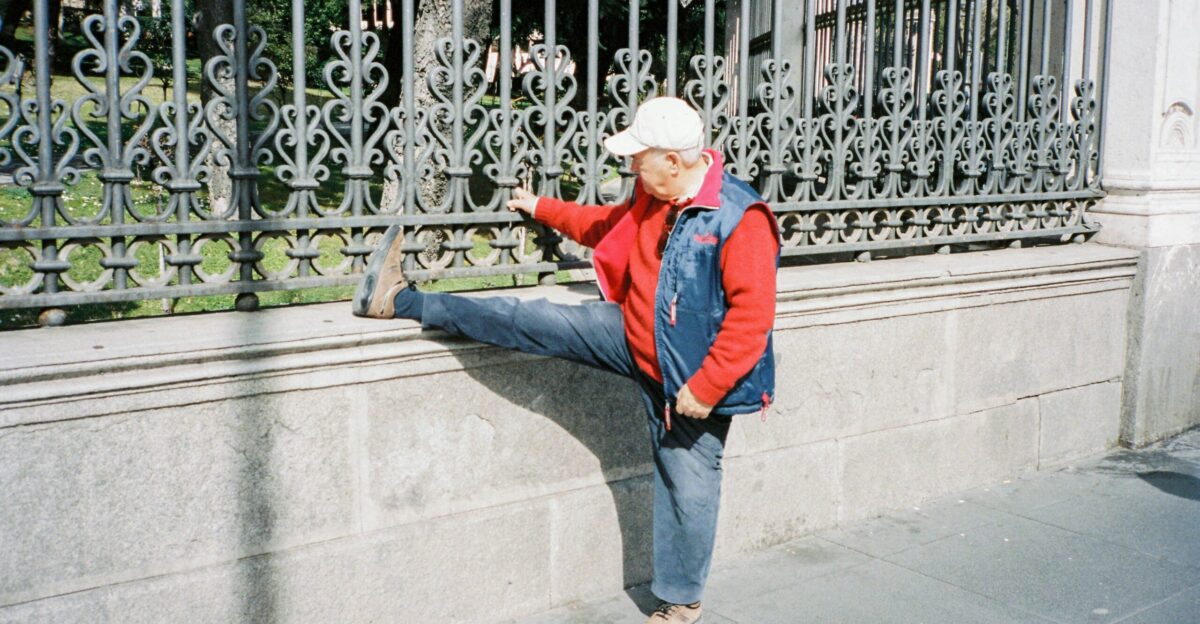 woman in blue jacket and blue denim jeans standing on gray concrete floor during daytime