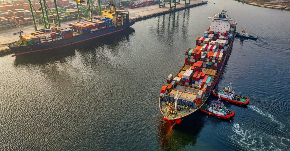 red and blue cargo ship on body of water during daytime