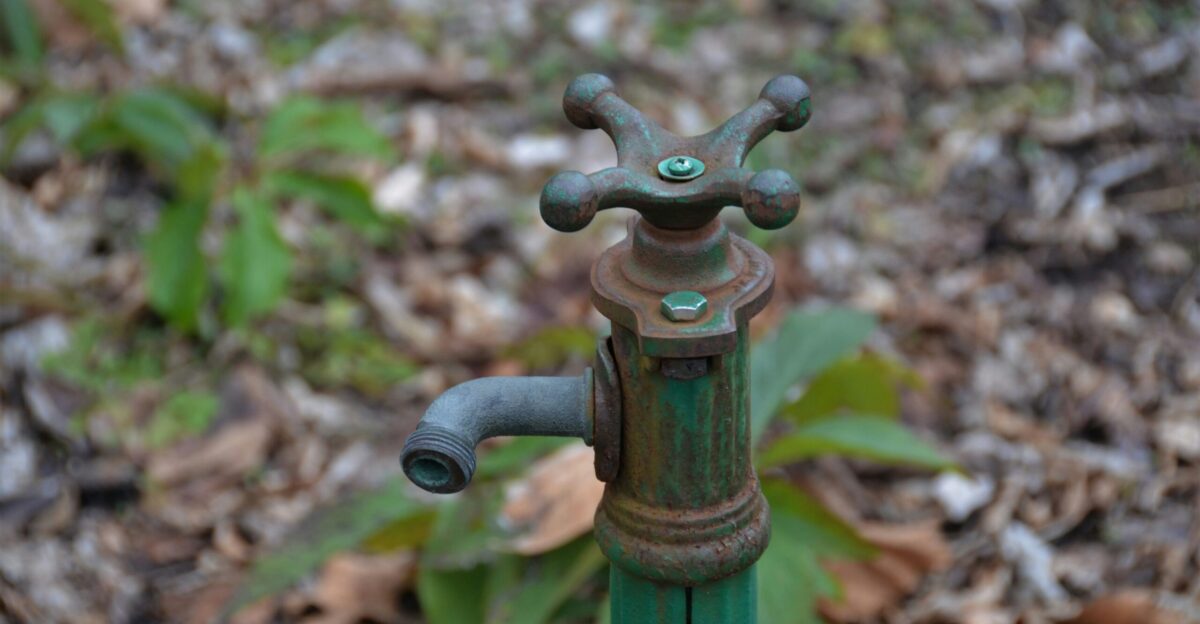 green and black metal pipe