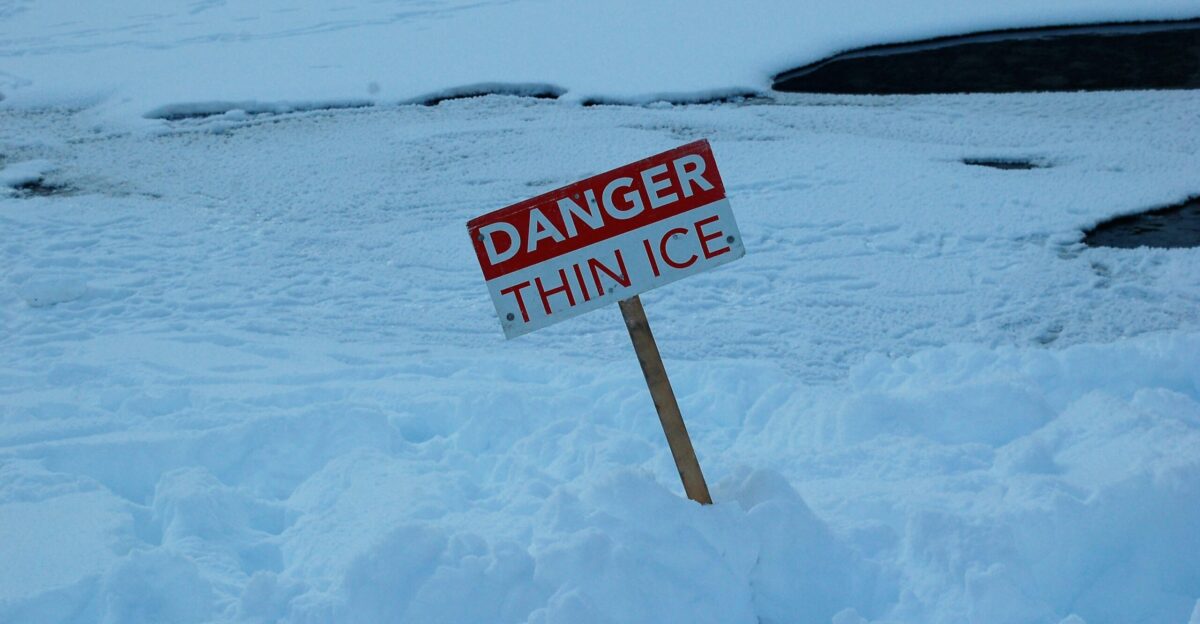 white and red open signage on snow covered ground