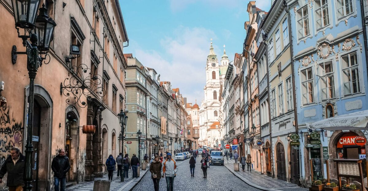 people walking on street between buildings during daytime