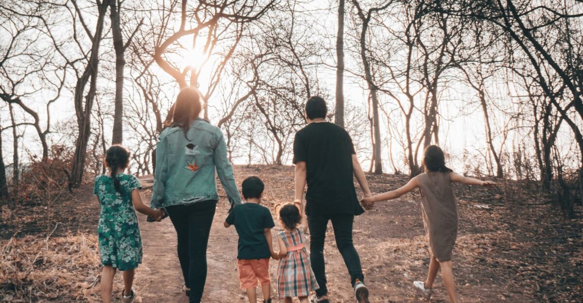 group of people standing on brown dirt road during daytime