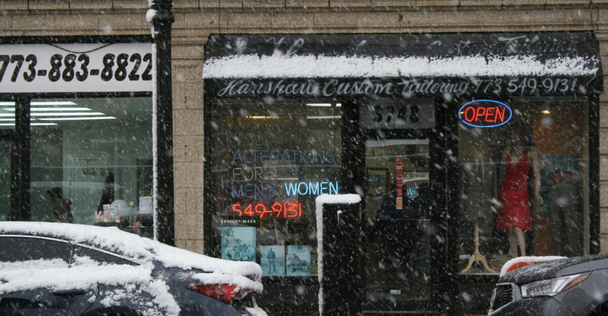 snow covered road near brown brick building during daytime