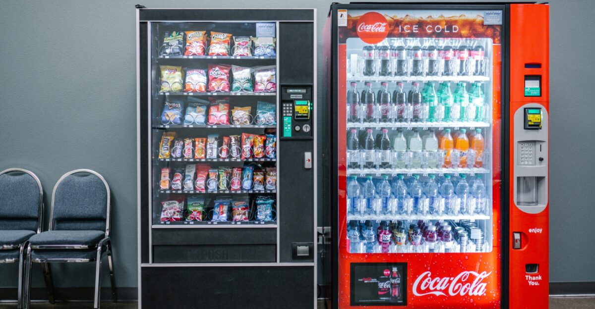 coca cola and coca cola bottles in black vending machine