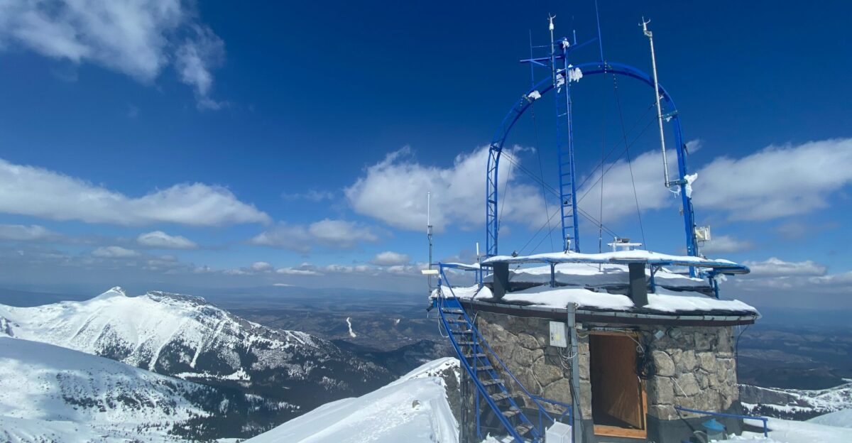 brown wooden house on snow covered mountain under blue sky during daytime