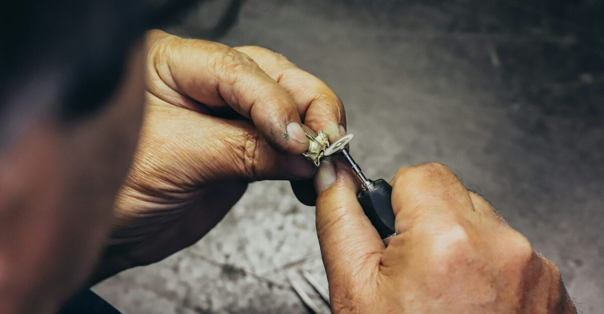 person holding silver and black hand tool